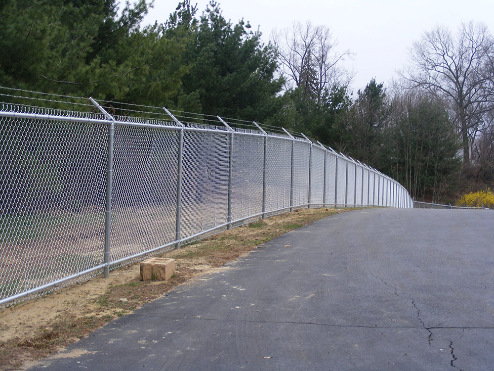 Commercial galvanized barbed wire fence installation in Metro Atlanta for high-security properties